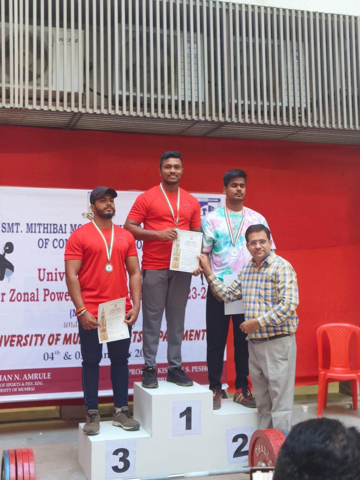 Devgad College's second year cadets Rushikesh Teli won gold medal at Mumbai University powerlifting competition. His total lift is: 587.5 kg.